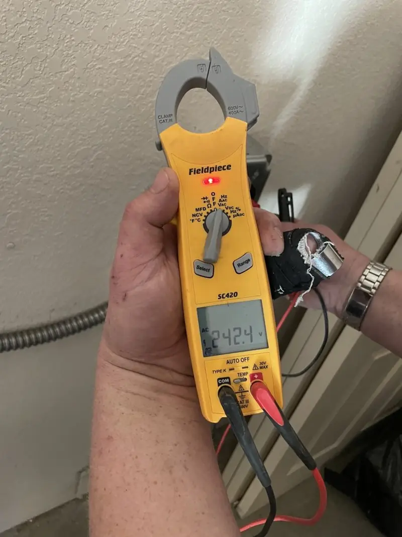 Voltage testing with clamp meter during Outlet Installation in Fletcher